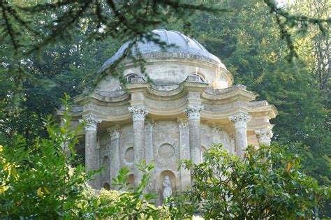 Families of macaque live near the temple, greeting visitors as they discover the cave. The Temple of Apollo, Stourhead Gardens, Stourton, near Me ...