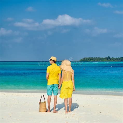 Couple In Yellow Running On A Beach At Maldives Stock Photo Image Of Lounge Nature