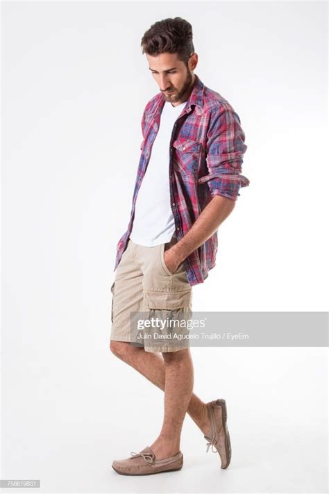 Handsome With Hands In Pockets Standing Against White Background