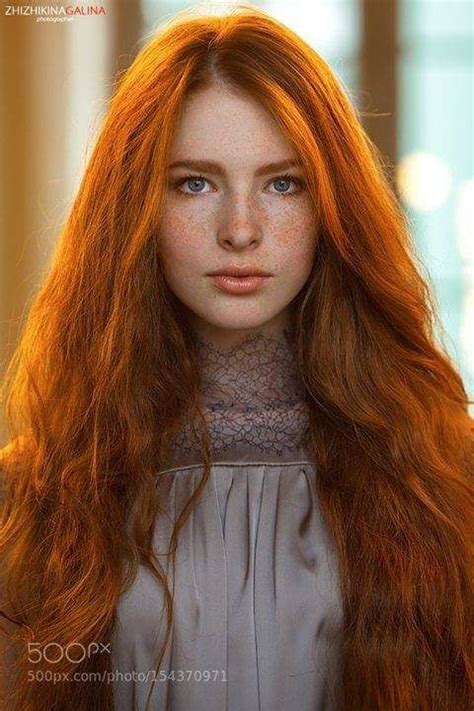 captivating look redhead long wavy red hair beauty portrait freckles stare woman