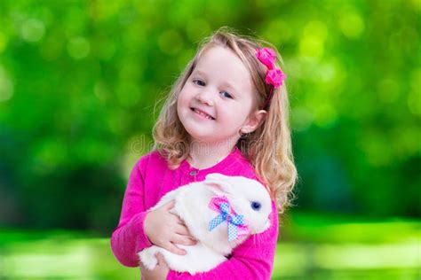 Little Girl Playing With Rabbit Stock Photo Image 59534742