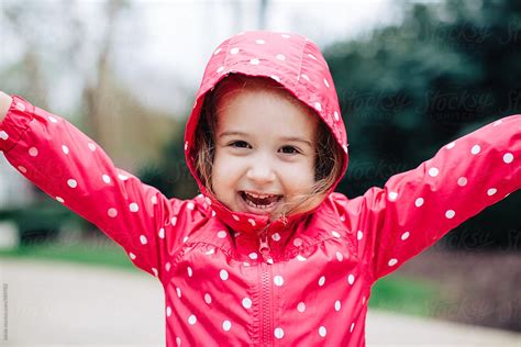 Adorable Young Girl Excited To Wear A New Rain Jacket Del Colaborador De Stocksy Jakob