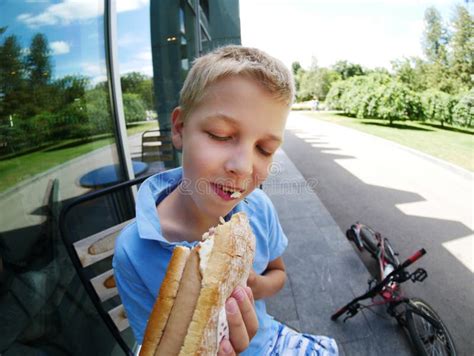 Boy Eats A Big Hot Dog With Sausage Stock Photo Image Of Bread