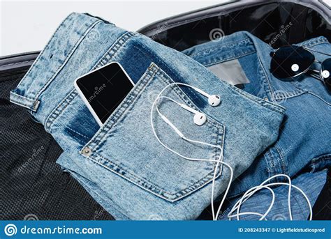 Top View Of Smartphone In Pocket Of Jeans Near Earphones Denim Shirt