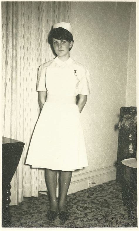 An Old Black And White Photo Of A Woman In A Nurses Uniform Posing For