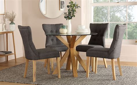 This versatile set is ideal for many uses. Hatton Round Oak and Glass Dining Table with 4 Bewley Slate Fabric Chairs | Furniture Choice