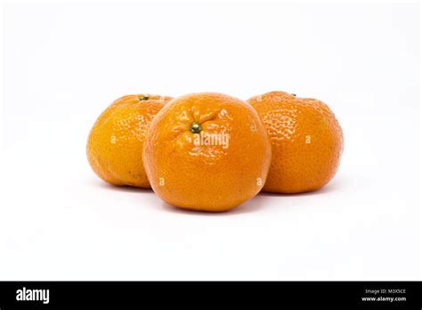 Three Clementines Citrus Clementine On A White Background Stock