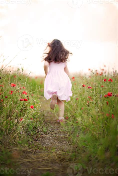 Little Girl Running Away In A Field Of Poppies 831685 Stock Photo At