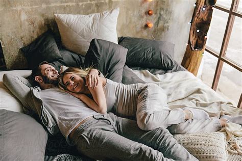 Happy Couple Embracing On Bed By Stocksy Contributor Andrey Pavlov Stocksy