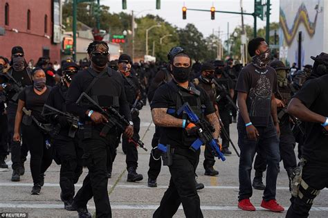 Hundreds Of Members Of An All Black Militia Raise Their Guns During