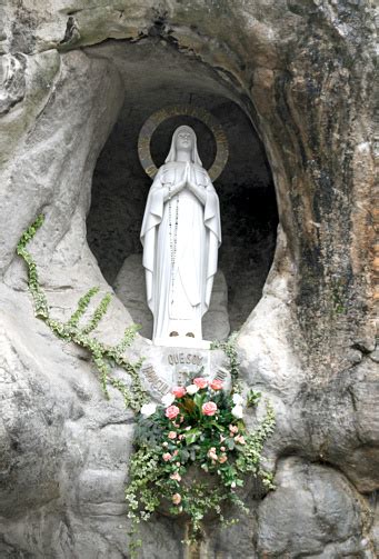 Statue Of The Virgin Mary In The Grotto Of Lourdes Stock Photo