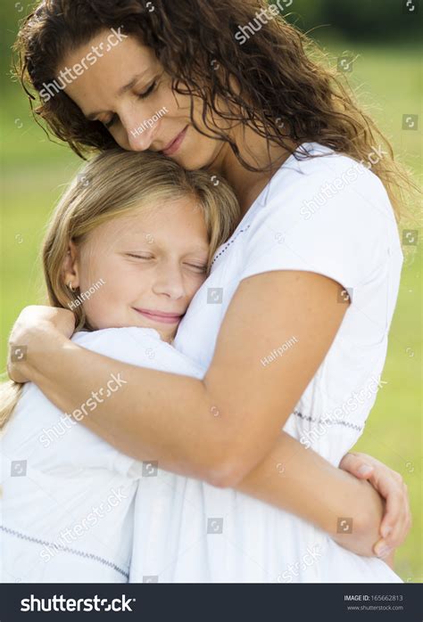 Mother Teenage Daughter Hugging Smiling Together写真素材165662813