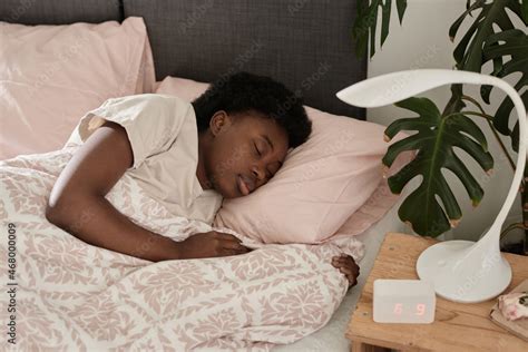 African Young Woman Sleeping In Her Comfortable Bed In The Bedroom