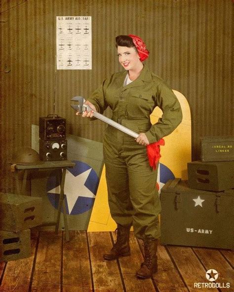 A Woman In An Army Uniform Is Holding A Large Wrench And Posing For The
