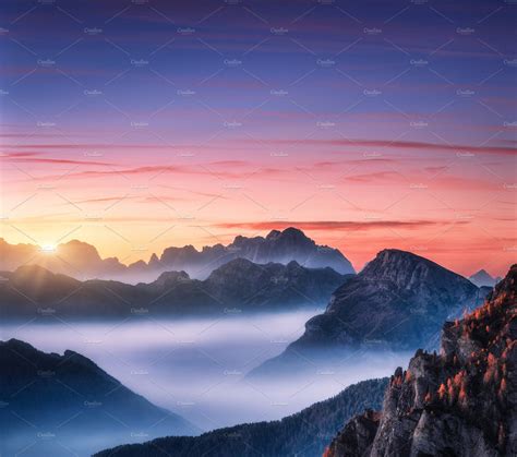 Mountains In Fog At Beautiful Sunset Featuring Mountain Rock And Fog