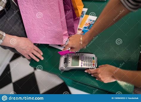At the very least, assuming you haven't incurred additional debt in the meantime, paying off the delinquent account balance will reduce the total amount of money you owe to all of. Close Shot Of Customer Making Payment With A Credit Card Stock Image - Image of style, store ...