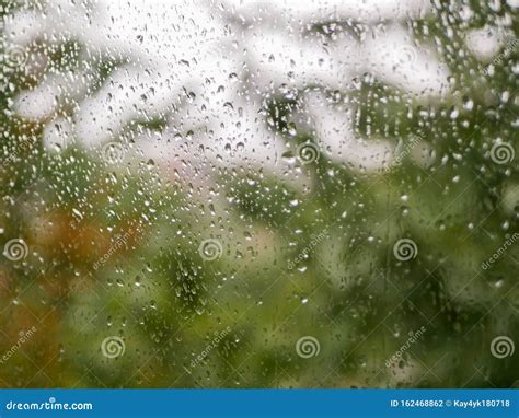 Raindrops On The Glass Rainy Weather Against The Background Of A