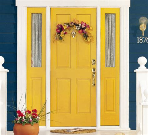 A Yellow Front Door With Flowers On It