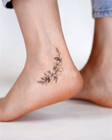 Small Black And White Flower Ankle Tattoo In 2021 Ankle Tattoos For
