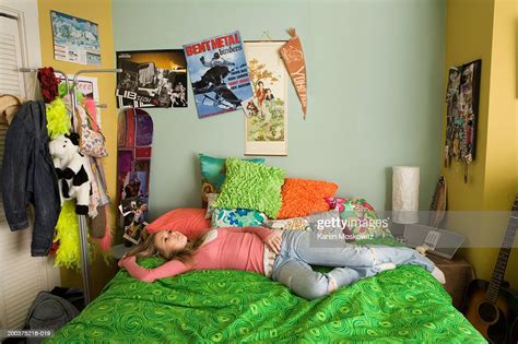 Teenage Girl Lying On Bed Staring At Ceiling Elevated View