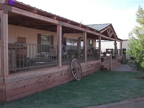 Covered porch with mountain view on front of home with fenced in front yard for the fur babies covered back porch, amish style building with 2 horse stalls and a hay/storage room. Love the rustic porch on this New Mexico horse ranch home ...
