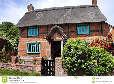 Thatched Cottage On An English Village Street Stock Photo