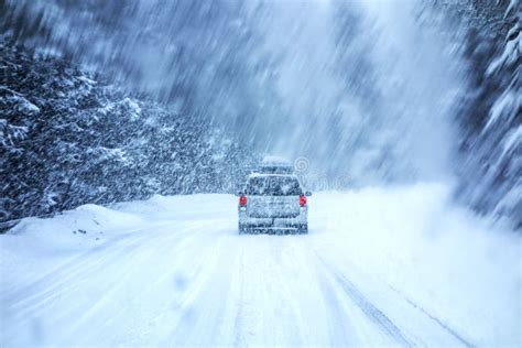 Car Driving On Snow Covered Road During Snowstorm Stock Image Image