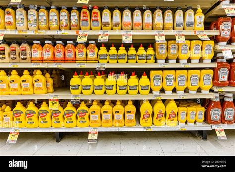 Assorted Brands Of Yellow Mustard Sauce Bottles Fully Stocked On