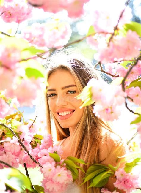 Spring Beauty Girl With Long Hair Outdoors Blooming Sakura Tree