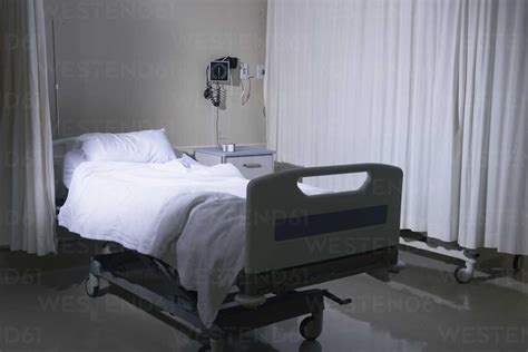 Empty Unmade Hospital Bed In Hospital Ward Stock Photo