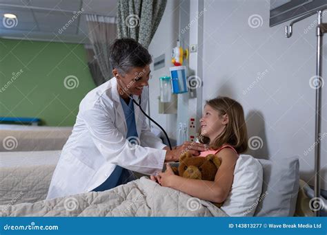 Doctor Examining Girl Patient In Clinic At Hospital Stock Image Image Of Girls Blanket
