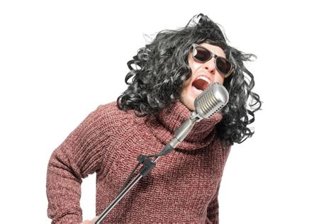 Premium Photo A Man In A Wig A Sweater And Sunglasses Singing Into A