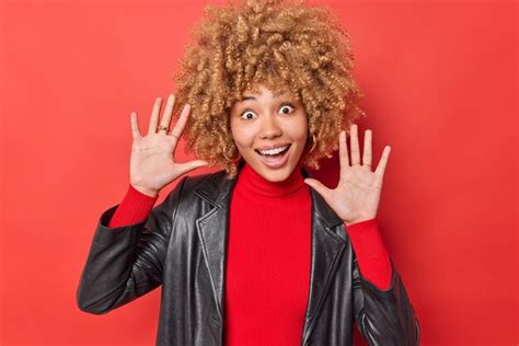 Free Photo Positive Playful Curly Haired Woman Keeps Palms Raised