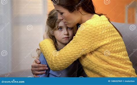 Upset Mother Hugging Shocked Daughter Feeling Pain Of Relative Loss