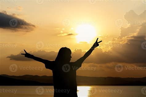 Silhouette Of Woman Standing Arms Raised In The Sunset Strong Female