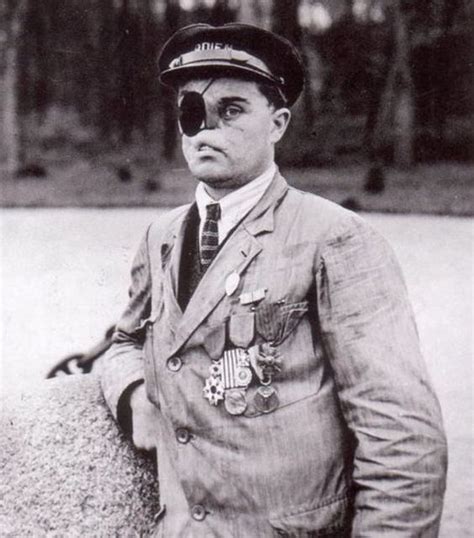 An Old Photo Of A Man In A Suit And Tie With Goggles On His Eyes