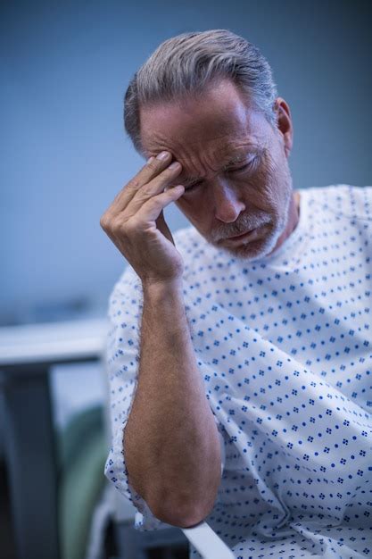 Premium Photo Sad Patient Sitting On Chair With Hand On Head