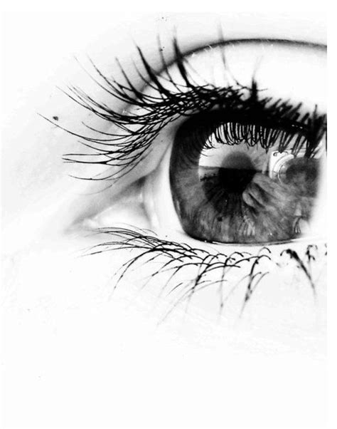 An Eye With Long Lashes Is Shown In Black And White
