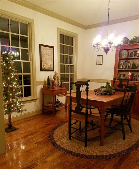 A Dining Room Table And Chairs With Christmas Decorations On The Wall