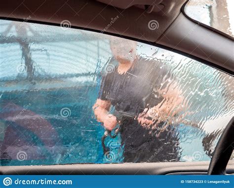 You will find an unattended terminal where you buy a car wash service. Man Washing Car With High-powered Hose At A Do It Yourself Car Wash Stock Image - Image of ...