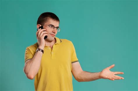 Free Photo Studio Shot Of A Clever Young Man In A Yellow Casual T