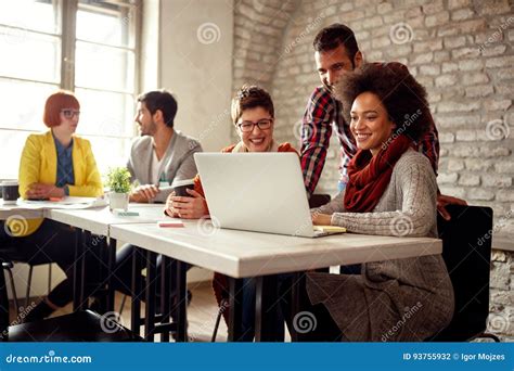 Smiling Coworkers Working Together On A Project Stock Photo Image Of