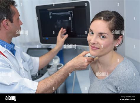 Woman Getting An Ultrasound Scan On Neck By Doctor Stock Photo Alamy