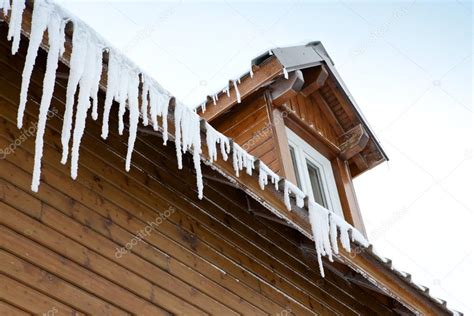 Icicles Hanging From A Roof Edge — Stock Photo © Photography33 18434995