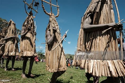 Circumcised Maasai Young Men Wearing A Ritual Costume Covered With