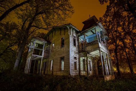 Old Creepy Wooden Abandoned Haunted Mansion At Night Stock Image