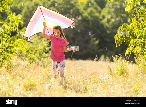 Little Girl Running Outdoor With A Kite Stock Photo Alamy