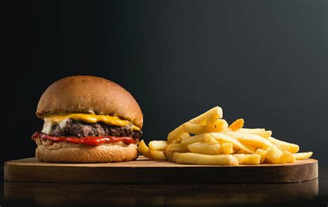 Classic Hamburger And French Fries On Wooden Board · Free Stock Photo