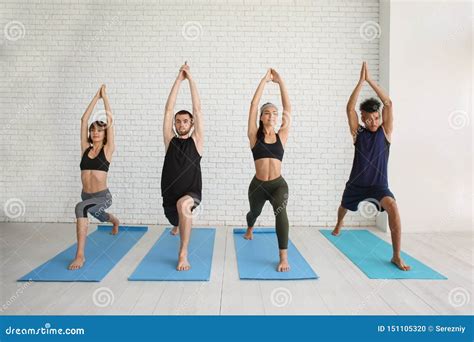 Group Of Sporty People Practicing Yoga Indoors Stock Photo Image Of