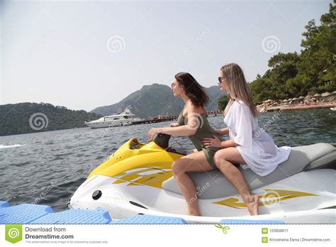 two beautiful girls riding a jet ski on the sea stock image image of happy girl 120938811